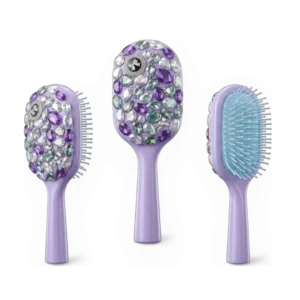Three views of a lavender purple hairbrush heavily decorated with various purple and clear gemstones on the back and handle.